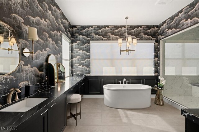 bathroom with tile patterned flooring, vanity, and a bathtub