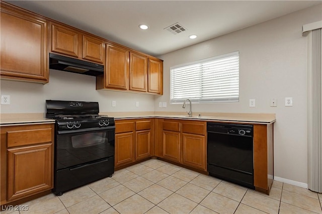 kitchen with light tile patterned flooring, sink, and black appliances