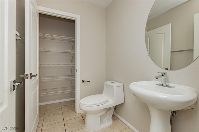 bathroom featuring sink, tile patterned floors, and toilet