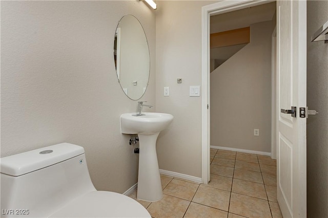 bathroom featuring tile patterned flooring and toilet