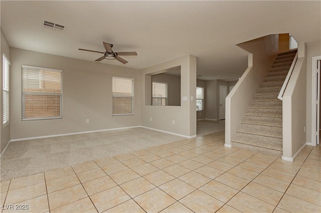 unfurnished living room with light tile patterned flooring and ceiling fan