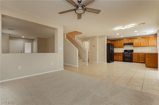 kitchen with sink, extractor fan, light colored carpet, ceiling fan, and black appliances