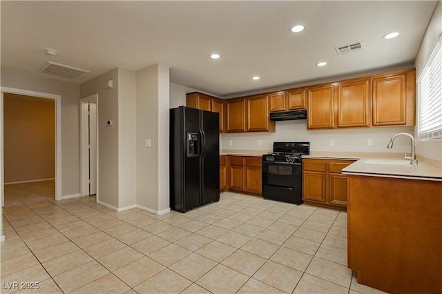 kitchen featuring light tile patterned flooring, sink, and black appliances