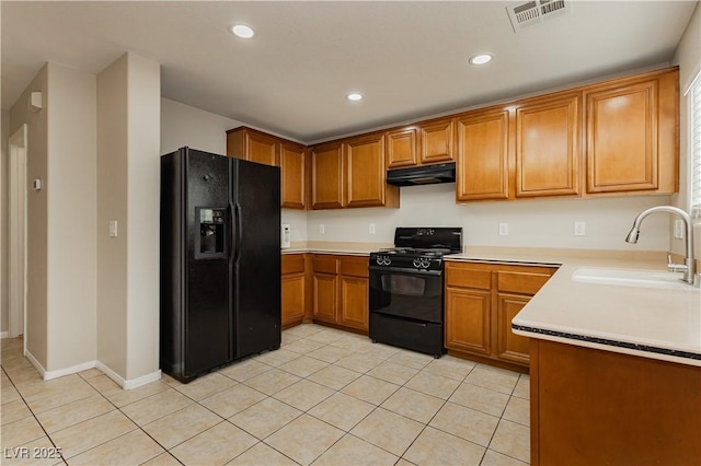 kitchen with light tile patterned flooring, sink, and black appliances