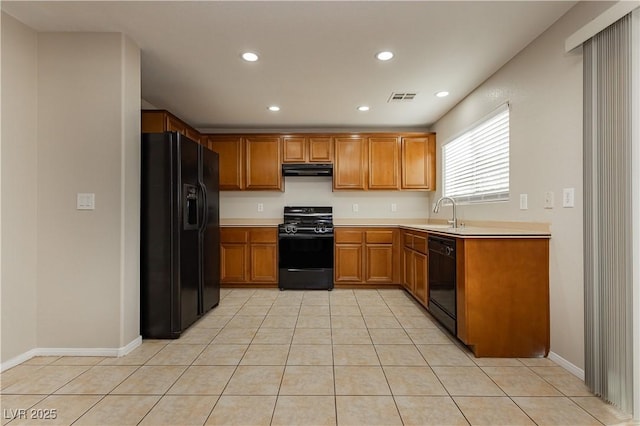 kitchen with light tile patterned flooring, sink, exhaust hood, and black appliances