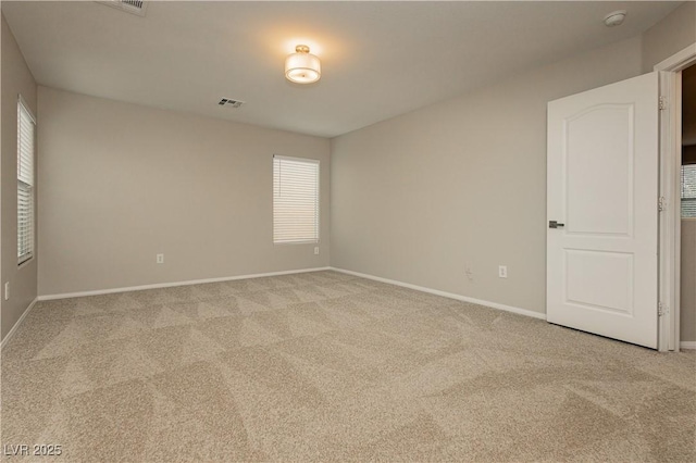 unfurnished room featuring light colored carpet