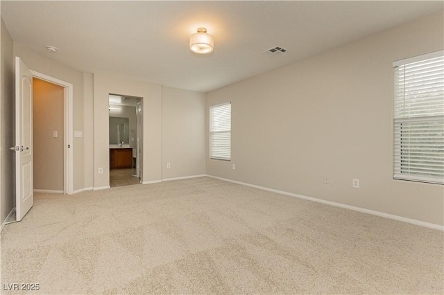 empty room with light colored carpet