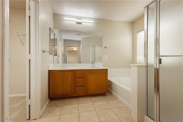 bathroom with vanity, tile patterned floors, and plus walk in shower