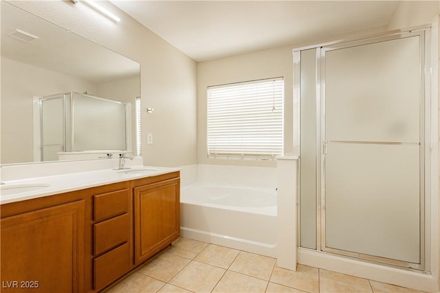 bathroom featuring tile patterned floors, shower with separate bathtub, and vanity