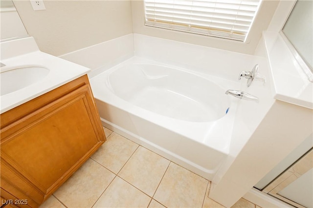 bathroom featuring tile patterned floors, a bathtub, and vanity