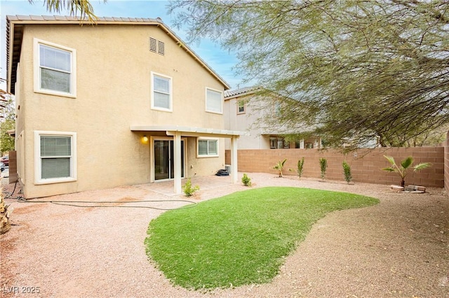 rear view of property featuring a patio