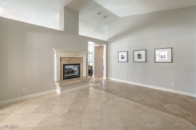 unfurnished living room featuring high vaulted ceiling and a fireplace