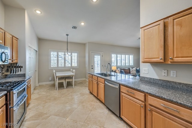 kitchen with pendant lighting, a healthy amount of sunlight, stainless steel appliances, and sink