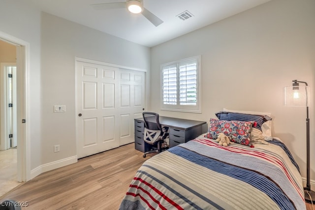 bedroom featuring light hardwood / wood-style floors, a closet, and ceiling fan