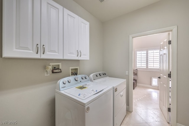 laundry area with cabinets and washing machine and dryer