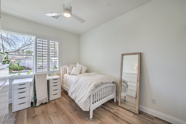 bedroom with hardwood / wood-style flooring and ceiling fan