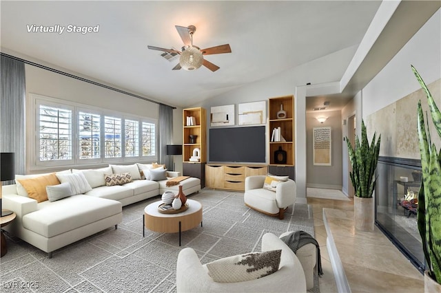 living room featuring vaulted ceiling and ceiling fan