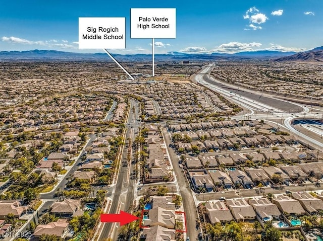 birds eye view of property featuring a mountain view