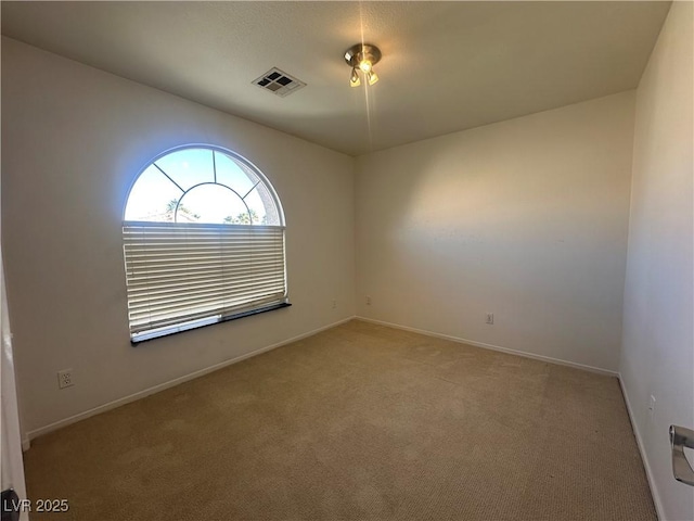 unfurnished room with light carpet