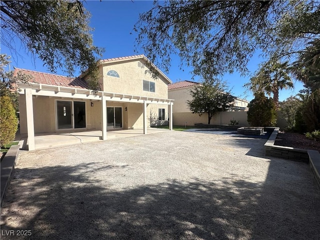 back of property with a patio