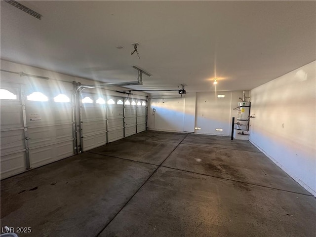 garage featuring a garage door opener and secured water heater