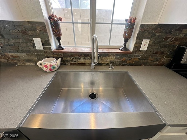 interior details with sink and decorative backsplash