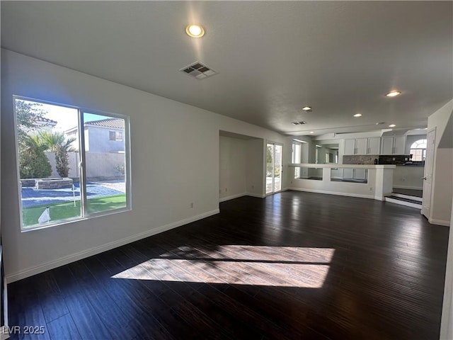 unfurnished living room with dark hardwood / wood-style floors