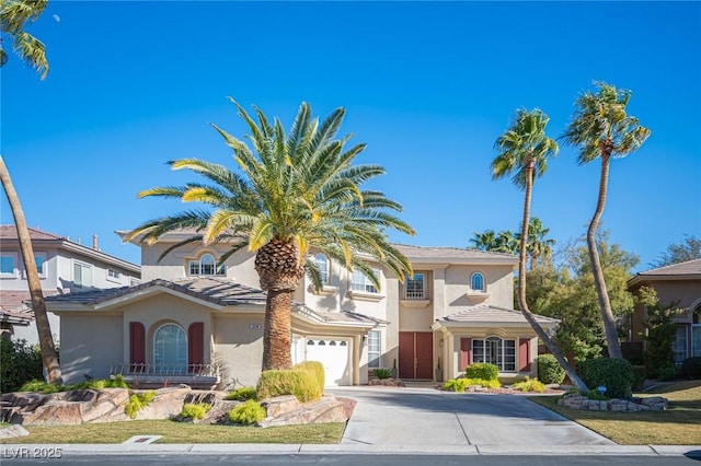 mediterranean / spanish-style home with a garage