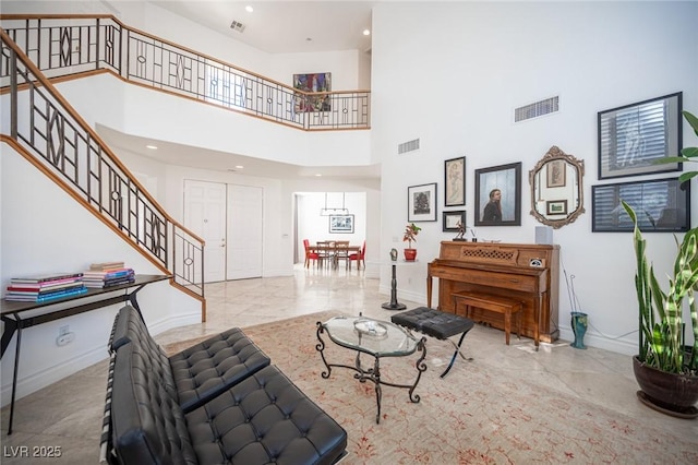 living room featuring a towering ceiling