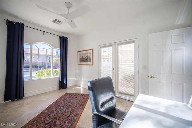 home office with french doors, ceiling fan, and light tile patterned floors