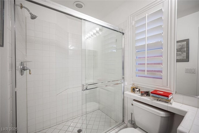 bathroom with toilet and an enclosed shower