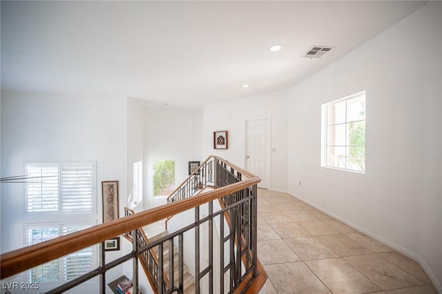 hall with light tile patterned floors