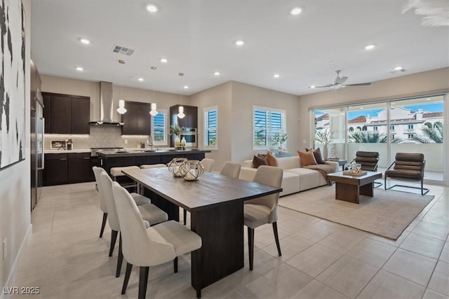 tiled dining area featuring a healthy amount of sunlight and ceiling fan