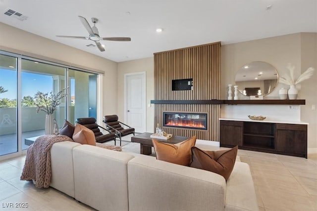 living room with ceiling fan and light tile patterned floors