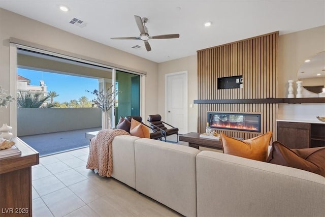 tiled living room featuring ceiling fan