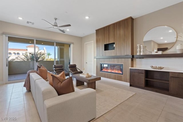 living room with ceiling fan and light tile patterned floors