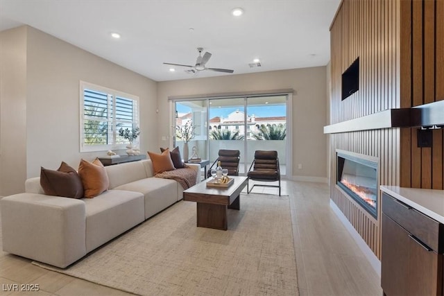 living room with plenty of natural light and ceiling fan