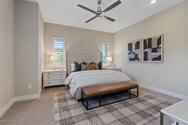 carpeted bedroom featuring multiple windows and ceiling fan