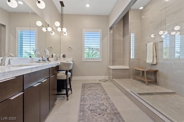 bathroom with vanity, tile patterned floors, and tiled shower