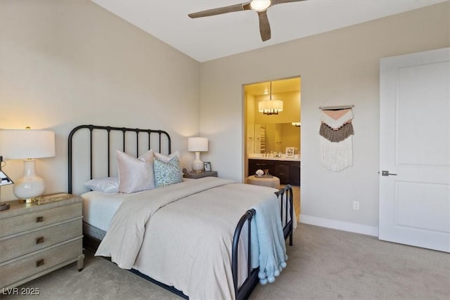 carpeted bedroom with ceiling fan and ensuite bathroom