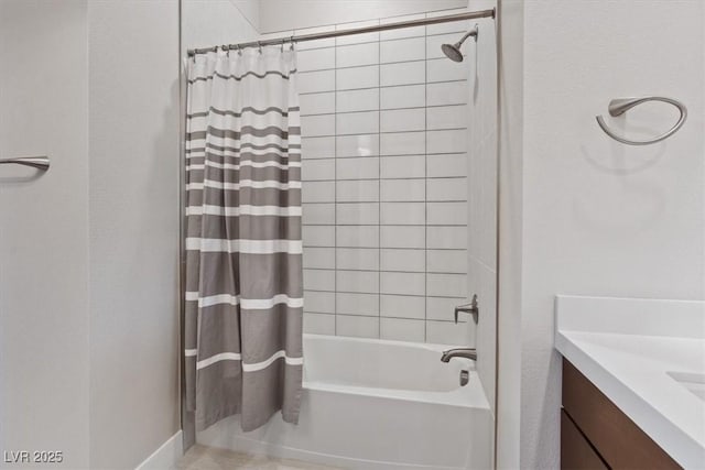 bathroom featuring vanity and shower / bathtub combination with curtain