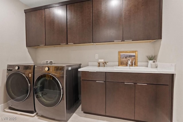 laundry area with sink, cabinets, and washing machine and clothes dryer