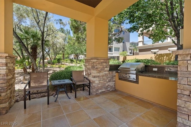 view of patio with area for grilling and a grill