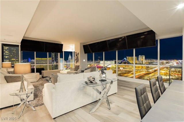 living room featuring hardwood / wood-style flooring and a wall of windows