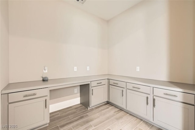 interior space with visible vents and wood tiled floor