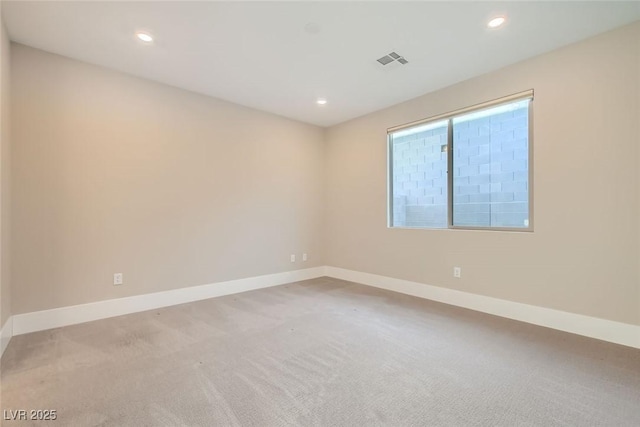 spare room with recessed lighting, visible vents, and baseboards