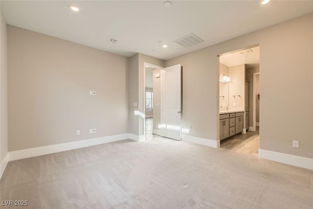 unfurnished bedroom with light carpet, recessed lighting, visible vents, and baseboards