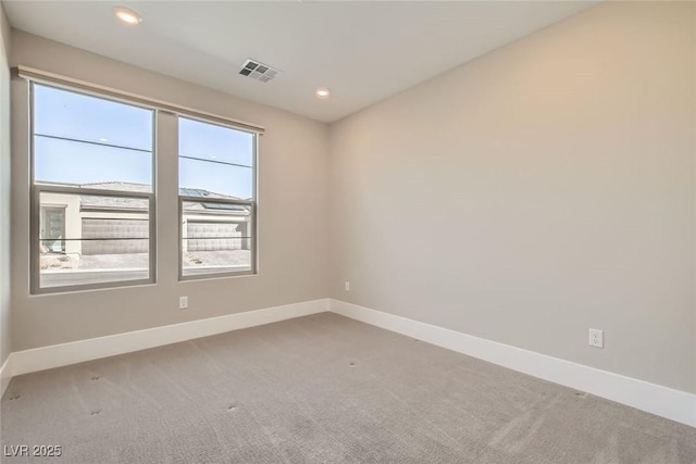 empty room featuring baseboards, visible vents, carpet flooring, and recessed lighting