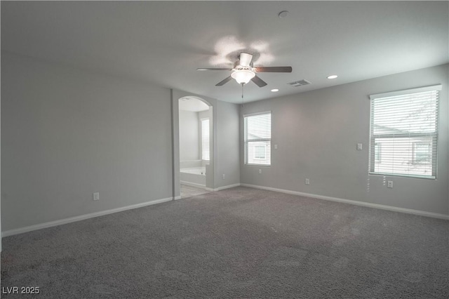 carpeted spare room with ceiling fan