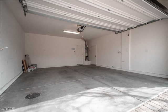 garage featuring a garage door opener and gas water heater